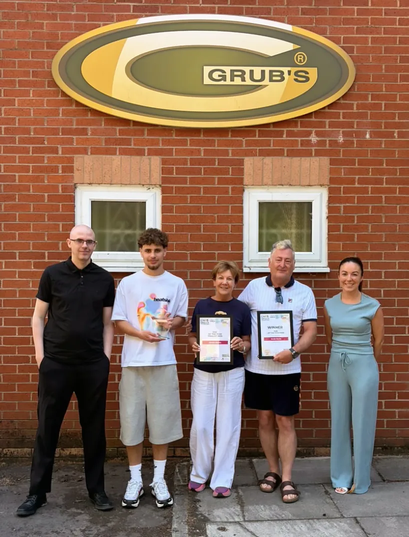 The Grubs team outside the Grubs warehouse holding their GM Skills Awards 2026 certificates